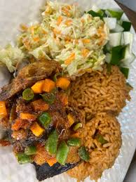 Jollof Rice, salad, plantain, and Titus Fish